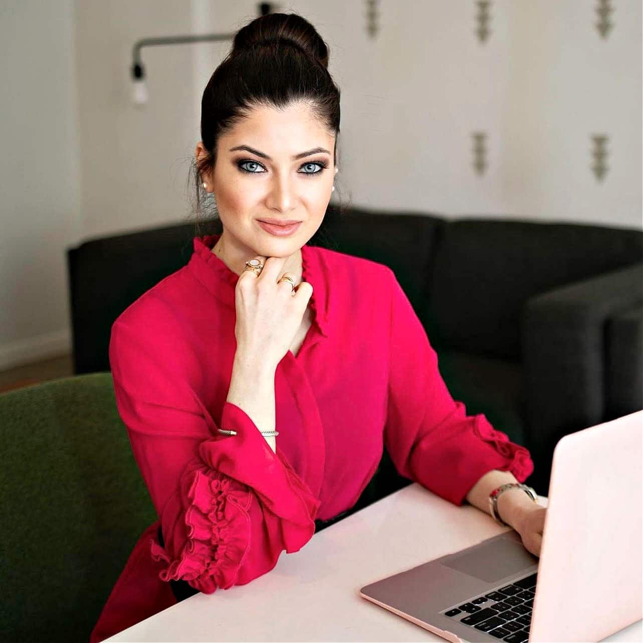 Dr. Yalda Safai sitting at her desk with computer